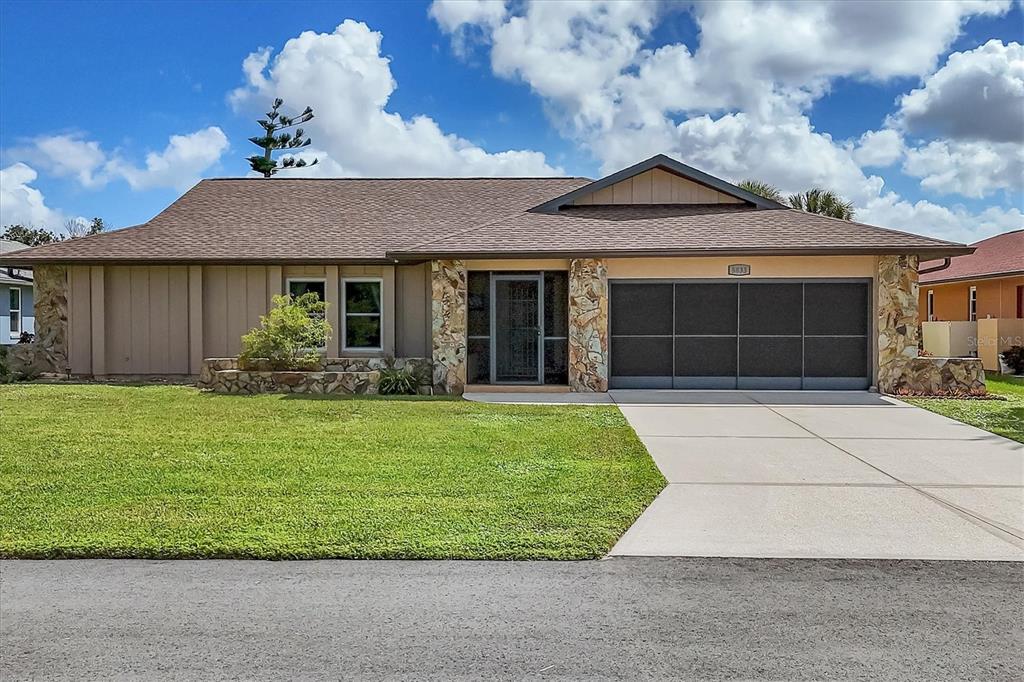 5833 Harrison Road Venice, FL 34293 - Photo 3 of 51 a front view of a house with a garden