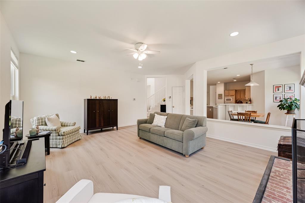 1406 West Peters Colony Road Carrollton, TX 75007 - Photo 28 of 29 a living room with furniture and a flat screen tv