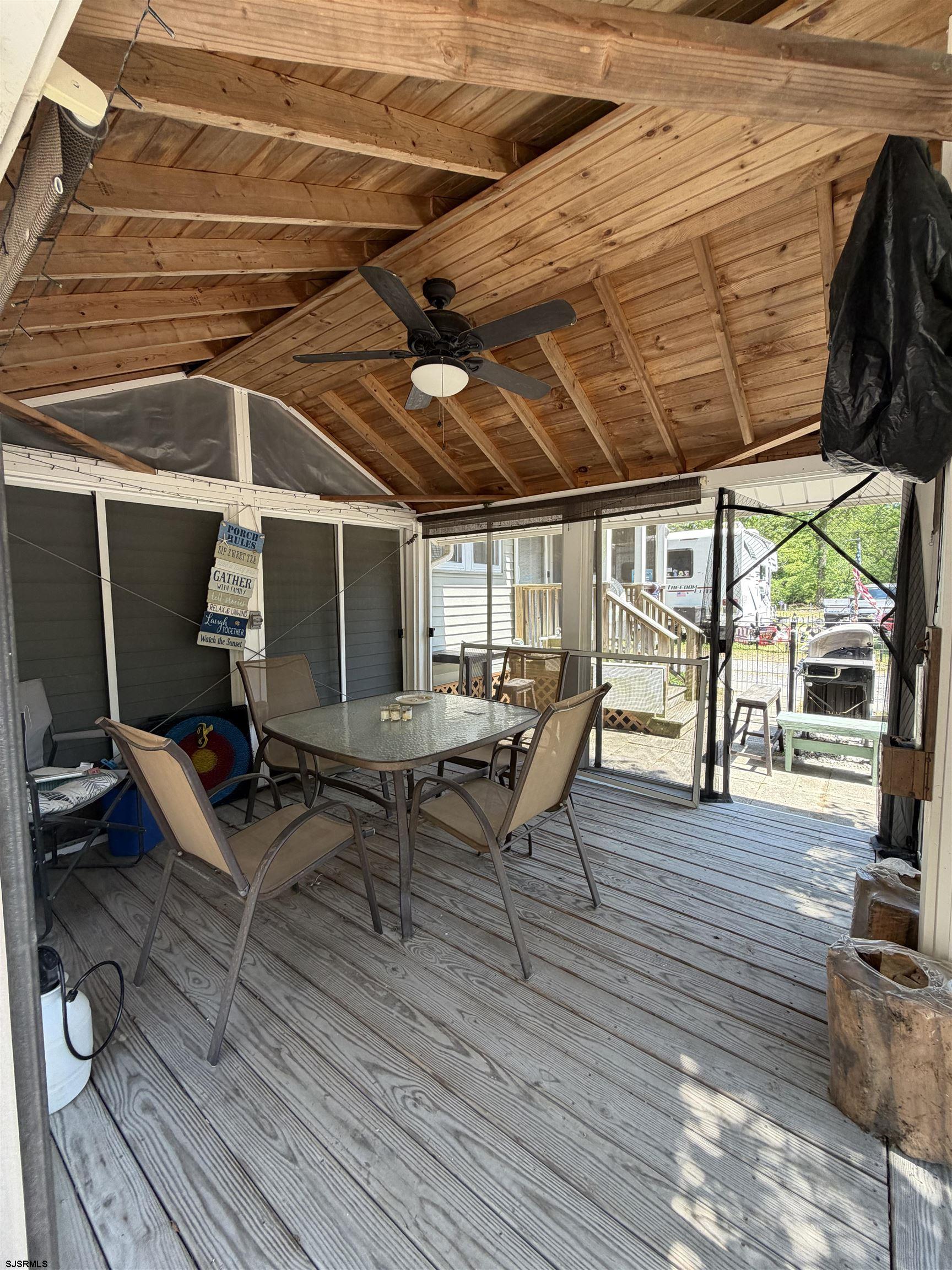 631 Chestnut Neck Road Port Republic, NJ 08241 - Photo 10 of 13 a view of a patio with table and chairs with wooden floor