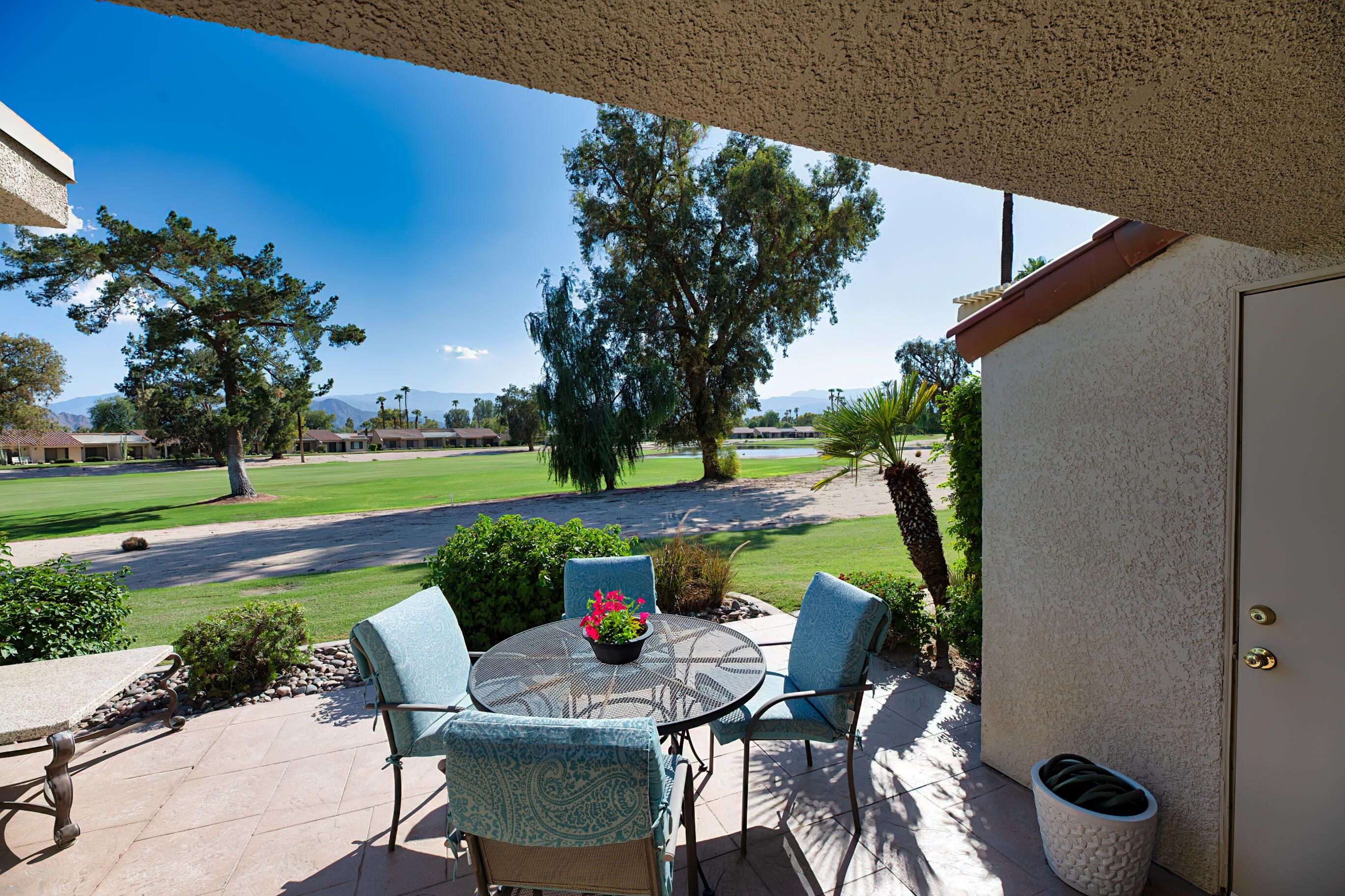 77361 Preston Trail Palm Desert, CA 92211 - Photo 17 of 47 a view of a chairs and table in patio with a yard