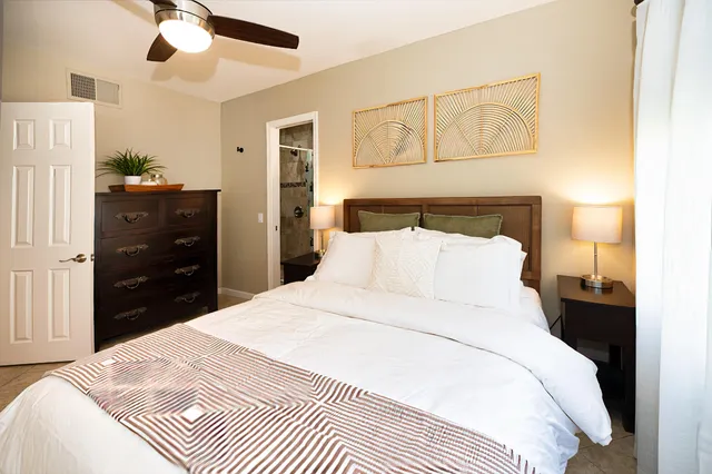 a bedroom with a bed and a chandelier