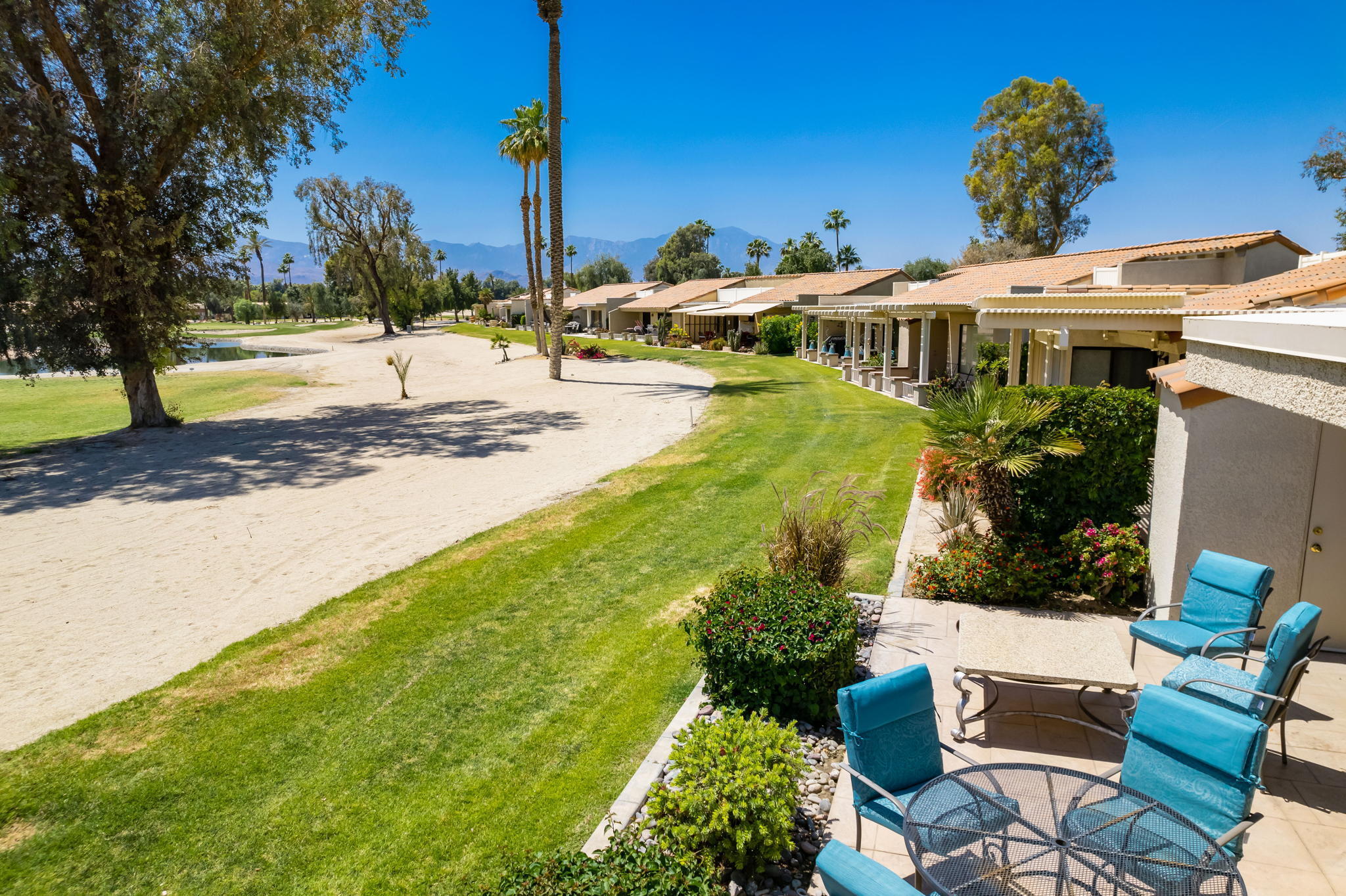 77361 Preston Trail Palm Desert, CA 92211 - Photo 30 of 47 a view of a patio with table and chairs potted plants