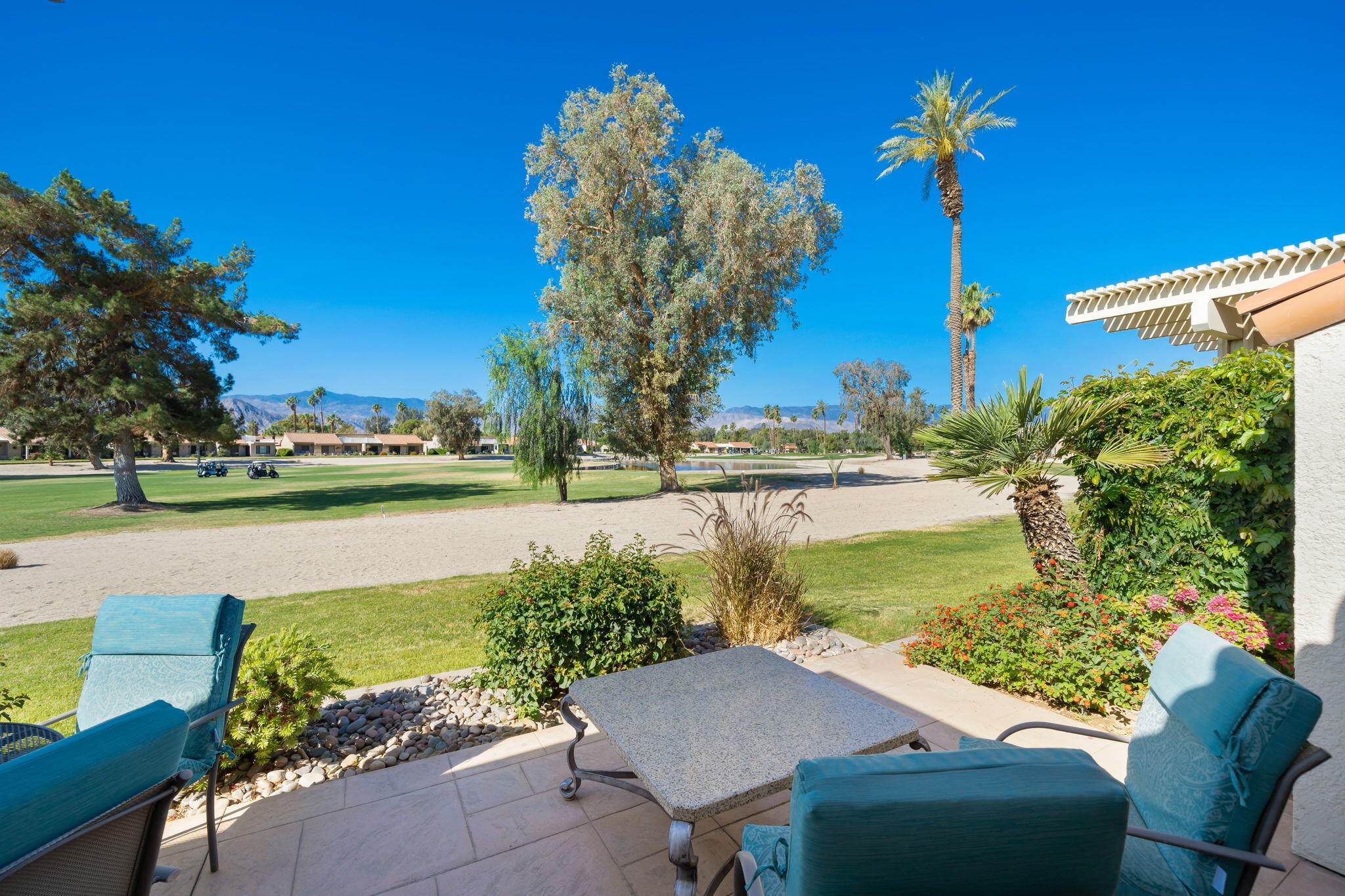 77361 Preston Trail Palm Desert, CA 92211 - Photo 46 of 47 a view of a lake with a house in the background