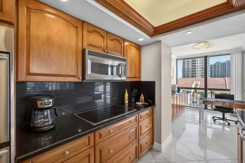 a spacious bathroom with a granite countertop sink and a mirror