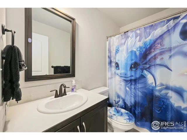 a living room with furniture and a book shelf