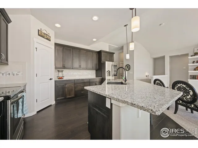 a kitchen with a sink a stove a refrigerator and a refrigerator