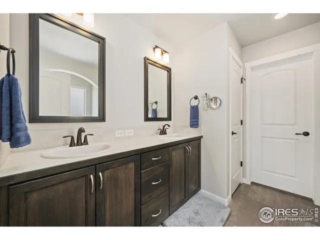 a bathroom with double vanity sinks and a mirror