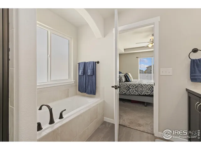 a en suite bathroom with a tub sink and mirror