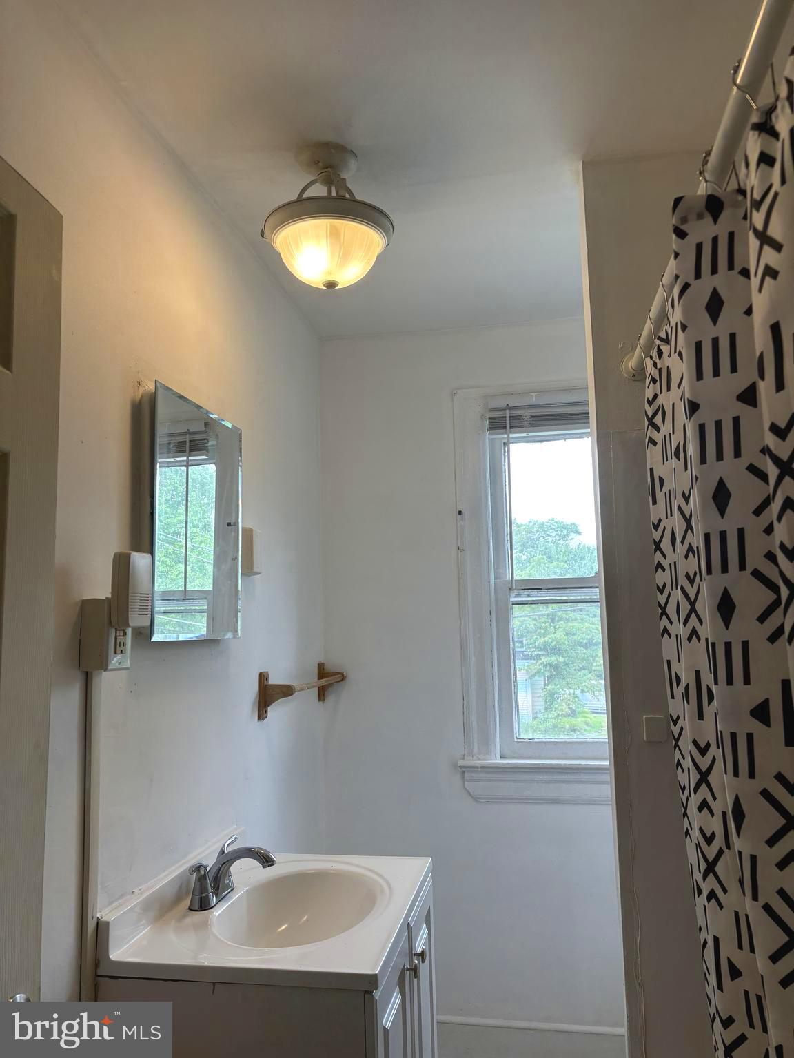 202 Cedar Avenue Pitman, NJ 08071 - Photo 16 of 27 a bathroom with a sink and a mirror
