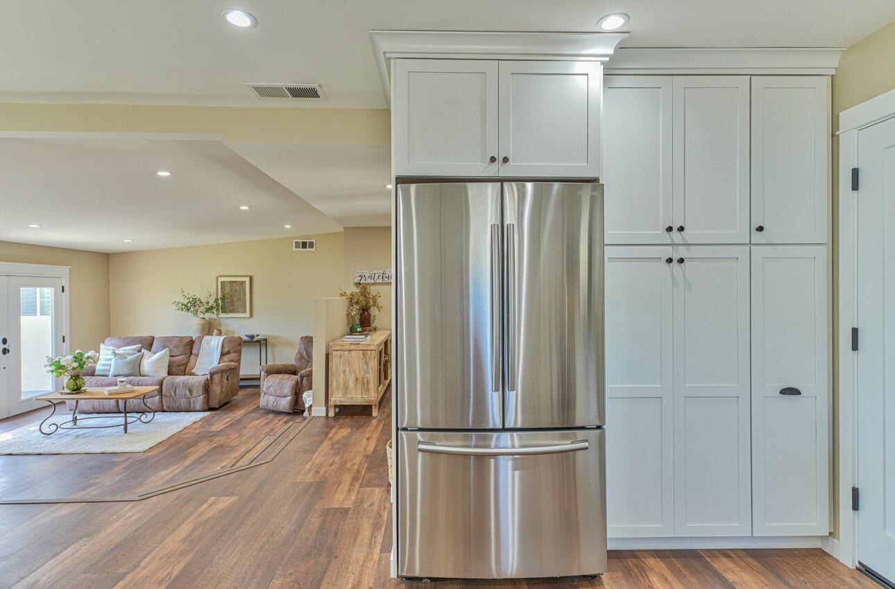 222 La Mesa Drive Salinas, CA 93901 - Photo 14 of 34 a view of a kitchen with a refrigerator and wooden floor
