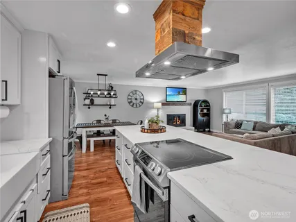 a kitchen with stainless steel appliances a stove sink and refrigerator