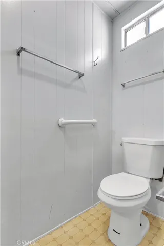 a white toilet sitting next to a shower