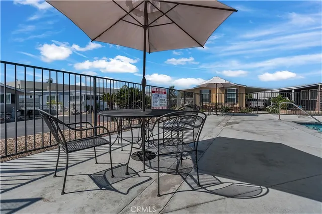 a room with pool table and windows