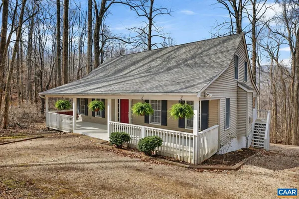 a view of a house with a small yard and wooden fence