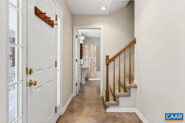 an empty room with windows and fireplace