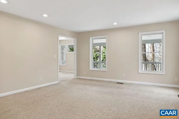 a view of a room with a windows and ceiling fan