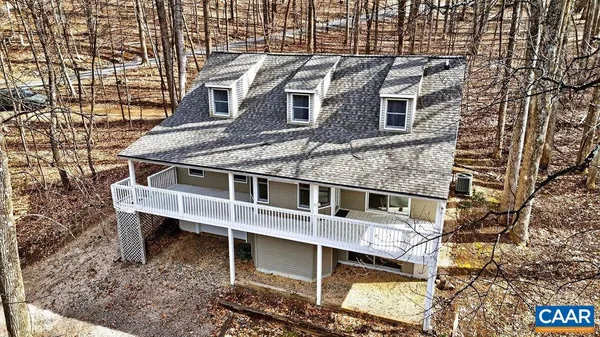 an empty room with windows and fireplace