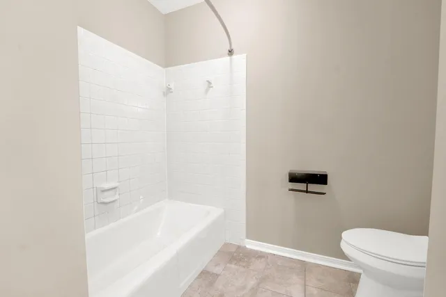 a bathroom with a bathtub and a toilet