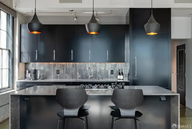 a kitchen with a table chairs sink and cabinets