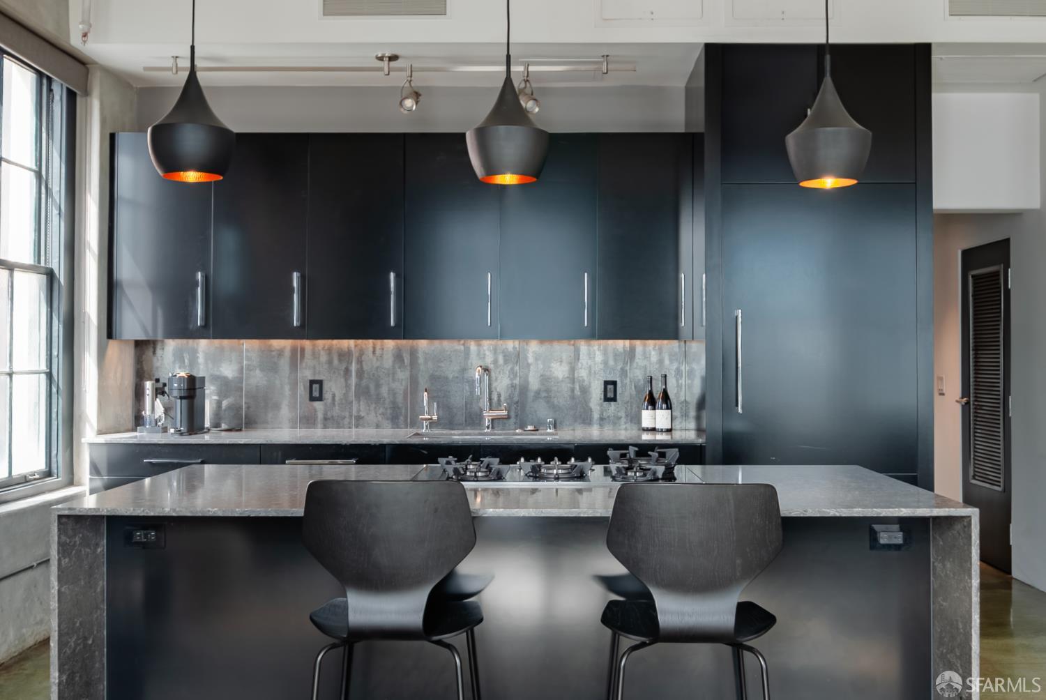 2 Mint Plaza, Unit 905 San Francisco, CA 94103 - Photo 1 of 21 a kitchen with a table chairs sink and cabinets