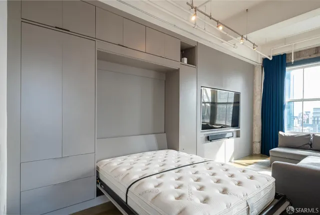 a bedroom with a bed and a couch