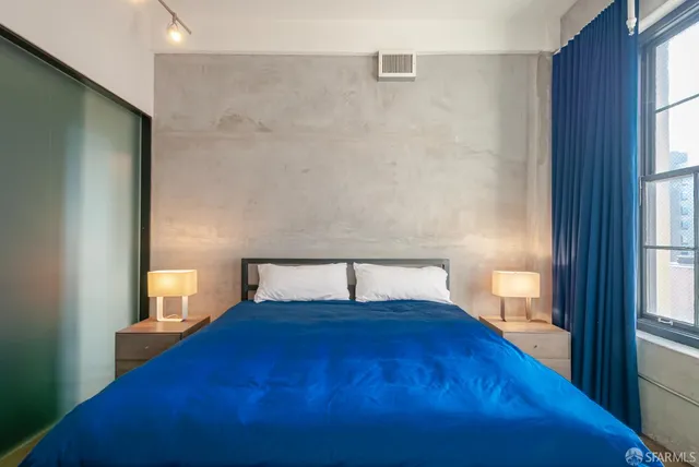 a bedroom with a bed and a window