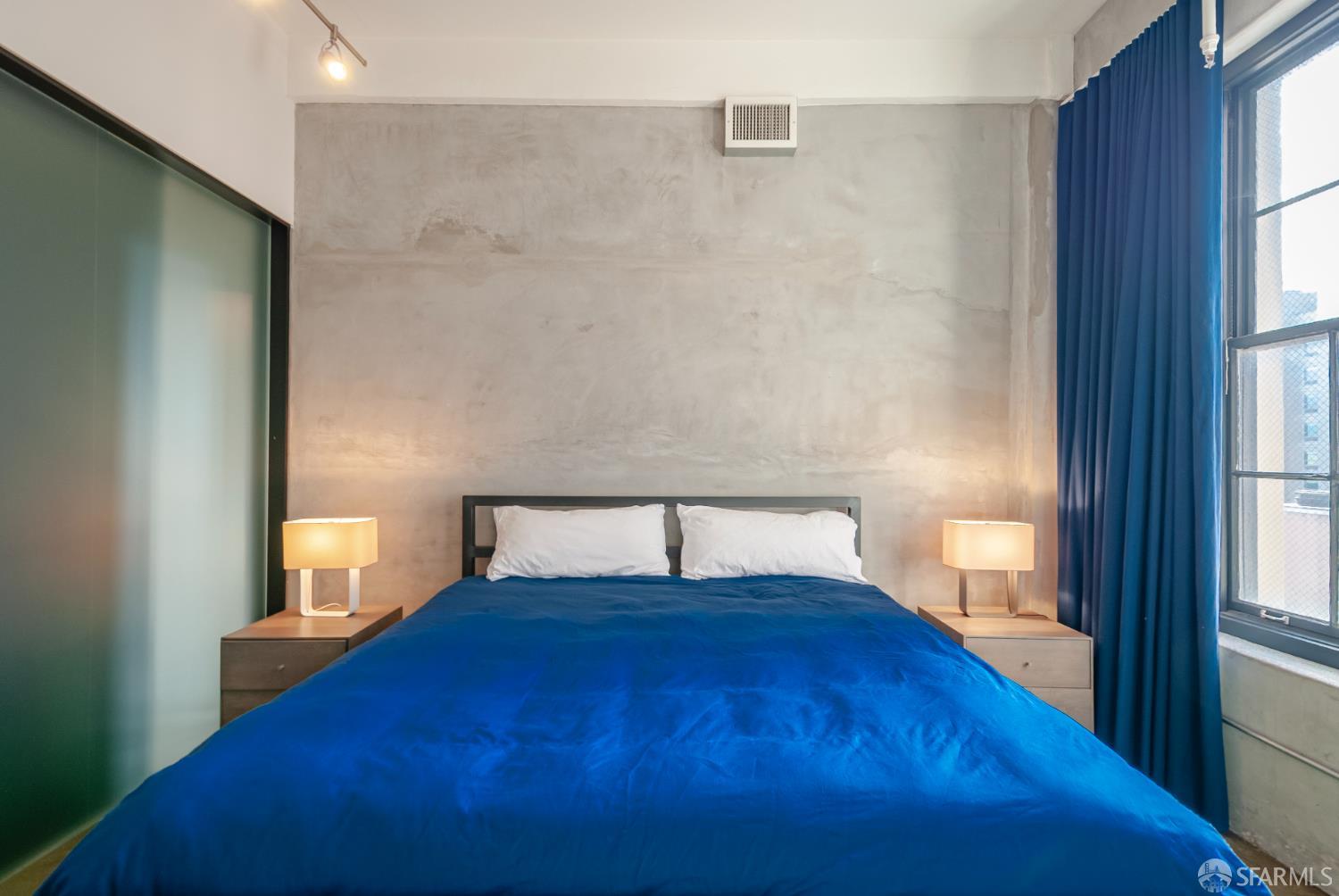 2 Mint Plaza, Unit 905 San Francisco, CA 94103 - Photo 15 of 21 a bedroom with a bed and a window