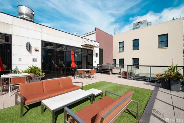 a view of a backyard with plants and patio