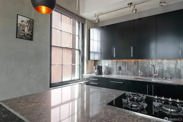 a kitchen with a sink and a stove top oven