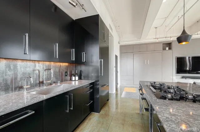 a kitchen with a sink and cabinets