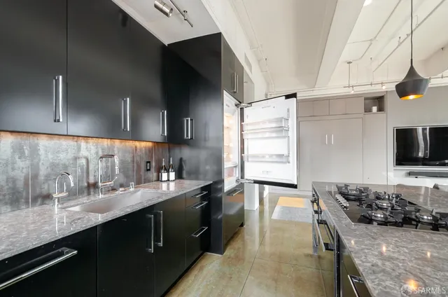 a kitchen with a sink stove and cabinets