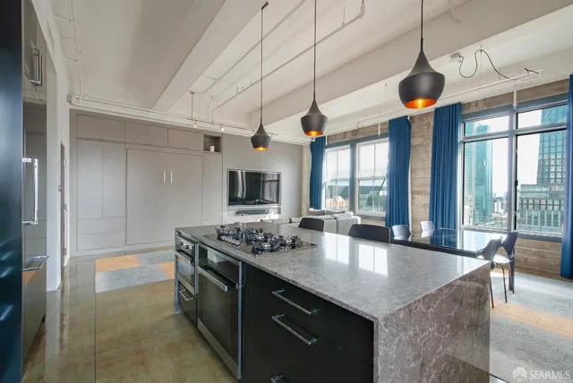 a kitchen with stainless steel appliances granite countertop a sink a stove and a refrigerator