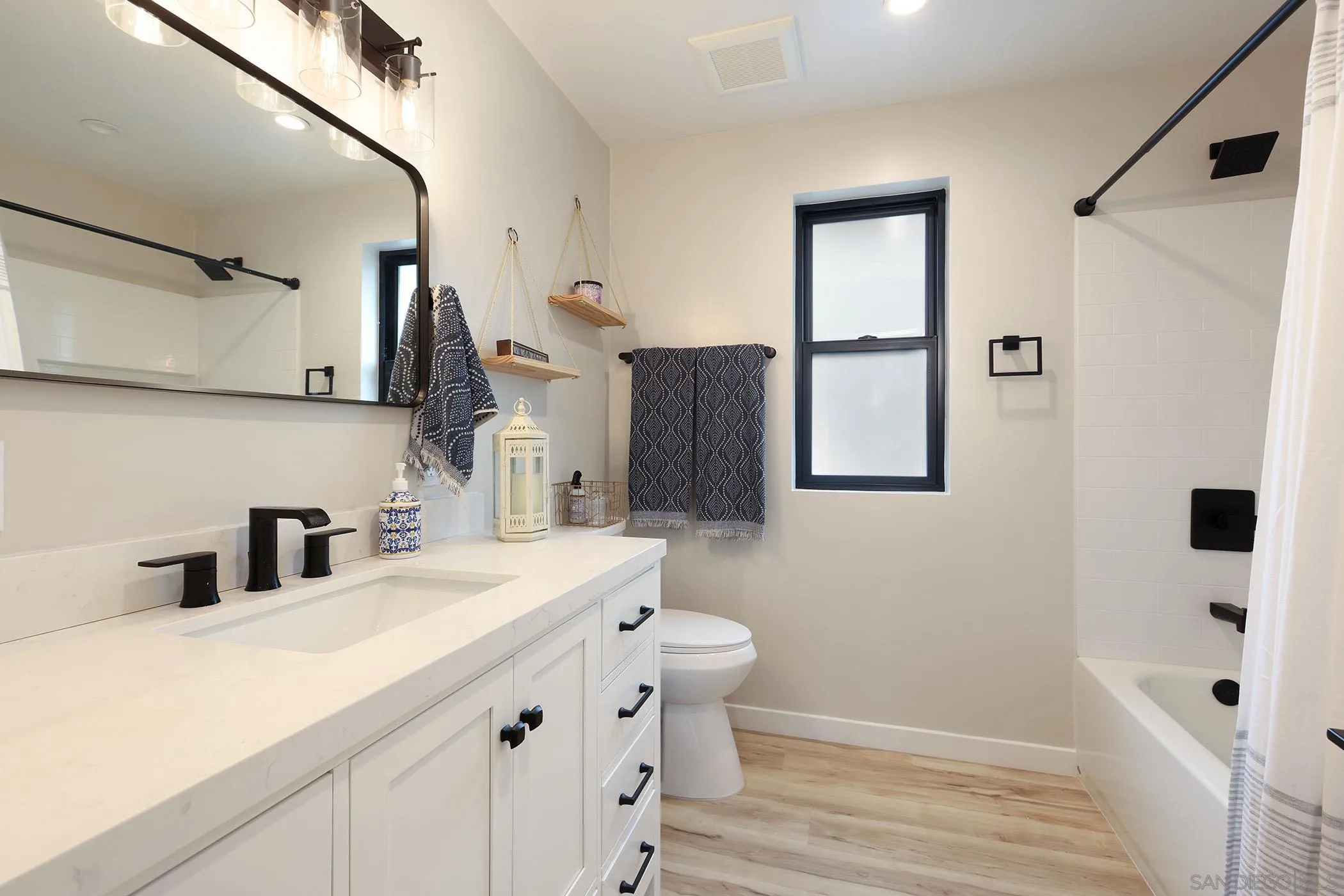 1686-88 Gecko Road Vista, CA 92083 - Photo 19 of 30 a bathroom with a sink a mirror and a shower