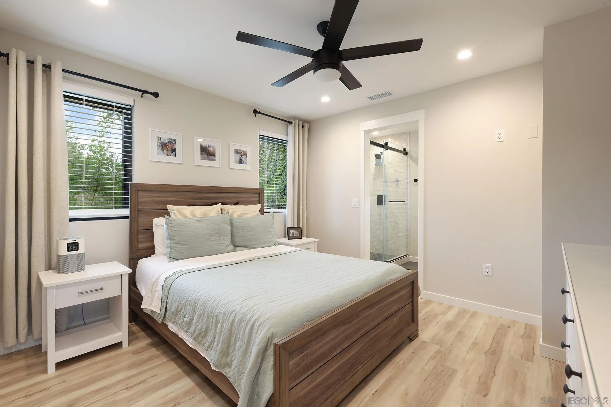 1686-88 Gecko Road Vista, CA 92083 - Photo 20 of 30 a bedroom with a large bed and a chandelier