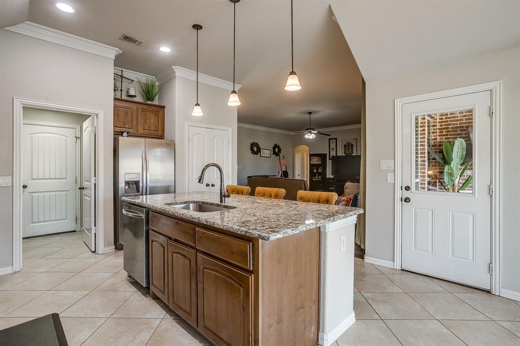 8005 Canyon Ridge Drive Godley, TX 76044 - Photo 17 of 40 a kitchen with a sink a counter space and stainless steel appliances