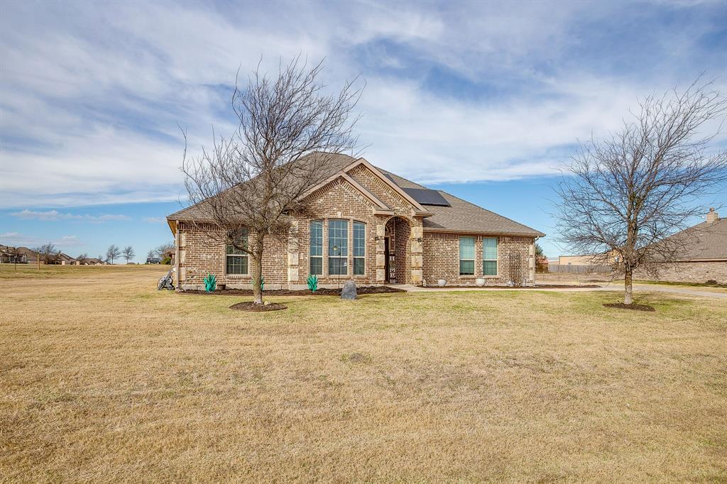 8005 Canyon Ridge Drive Godley, TX 76044 - Photo 2 of 40 a view of a house with a yard and large tree