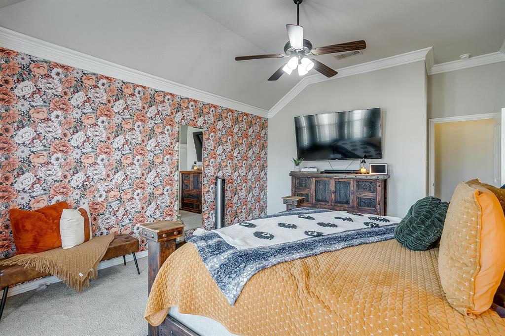 8005 Canyon Ridge Drive Godley, TX 76044 - Photo 23 of 40 a bedroom with a bed and a flat screen tv