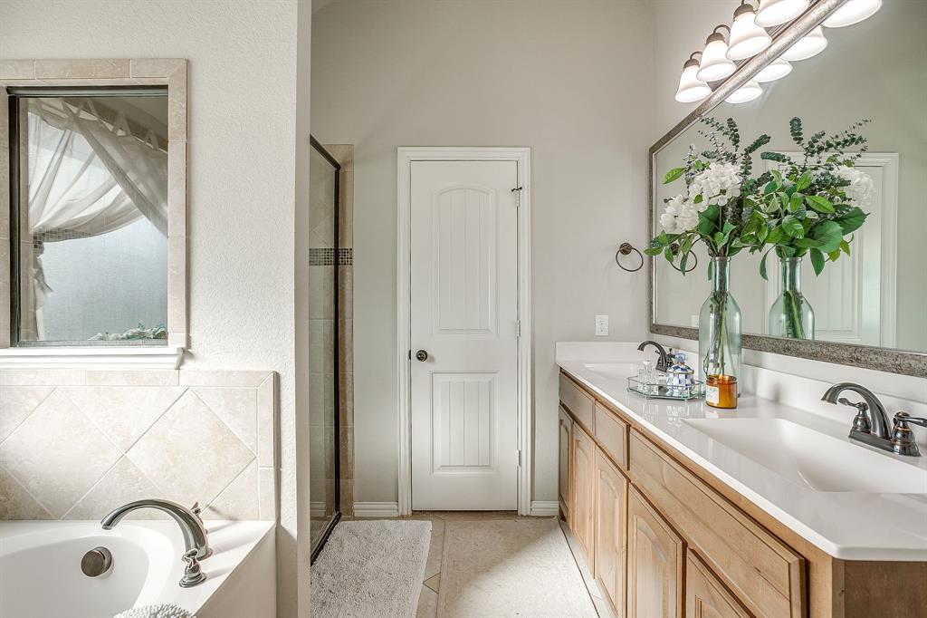 8005 Canyon Ridge Drive Godley, TX 76044 - Photo 26 of 40 a bathroom with a sink a mirror and a shower