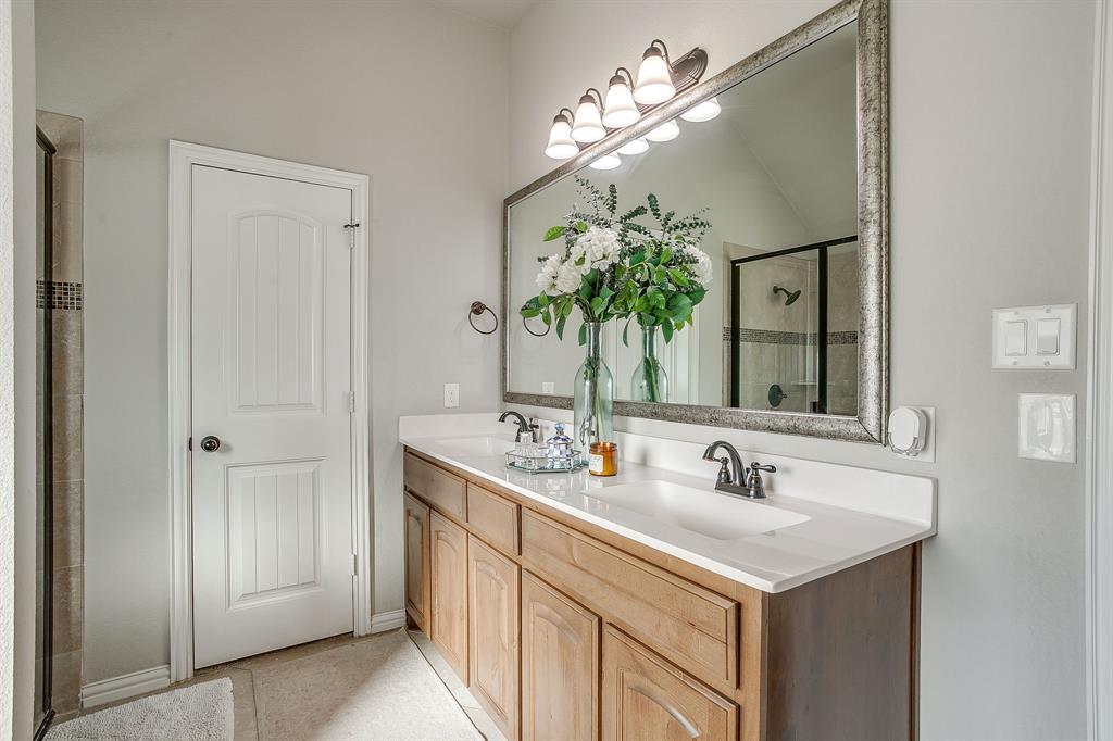8005 Canyon Ridge Drive Godley, TX 76044 - Photo 27 of 40 a bathroom with a sink and a mirror