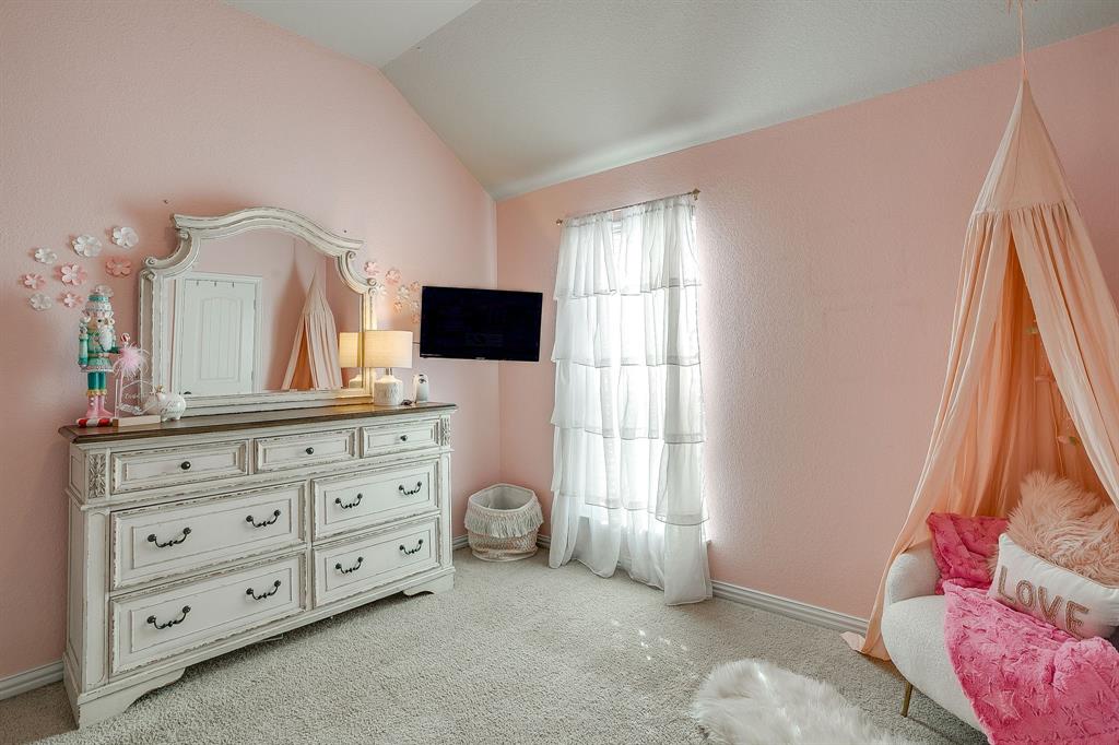 8005 Canyon Ridge Drive Godley, TX 76044 - Photo 29 of 40 a bedroom with a bed and a flat tv screen on dresser