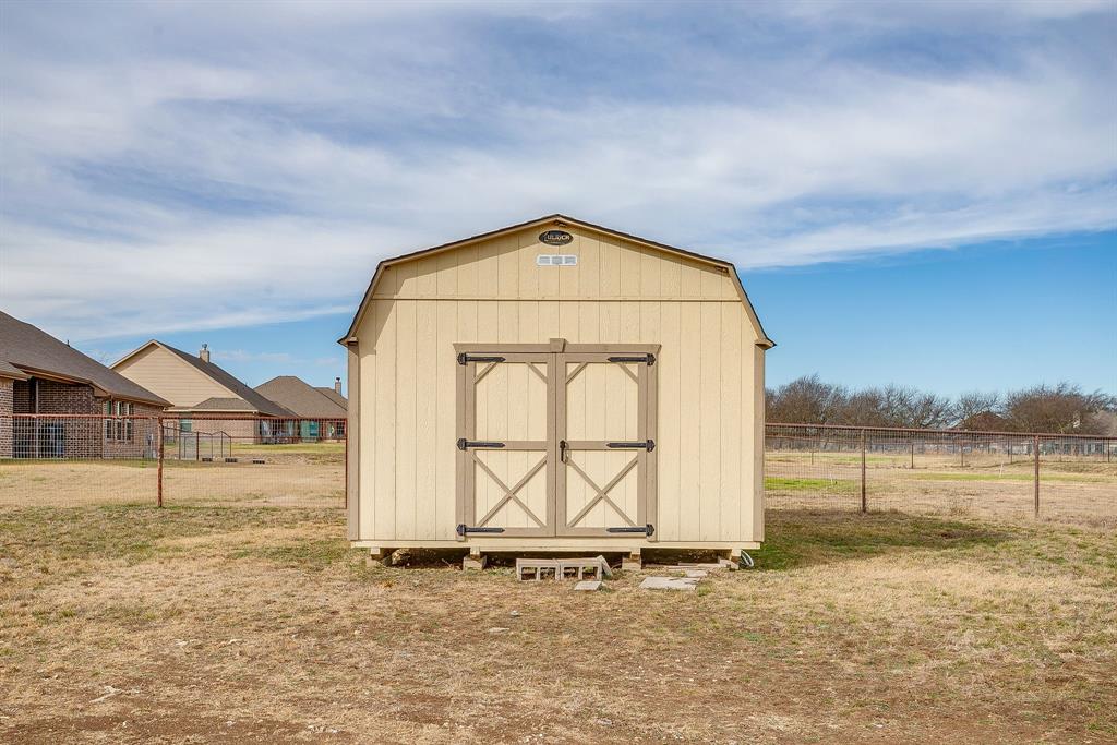 8005 Canyon Ridge Drive Godley, TX 76044 - Photo 39 of 40 a view of a house with a ocean beach