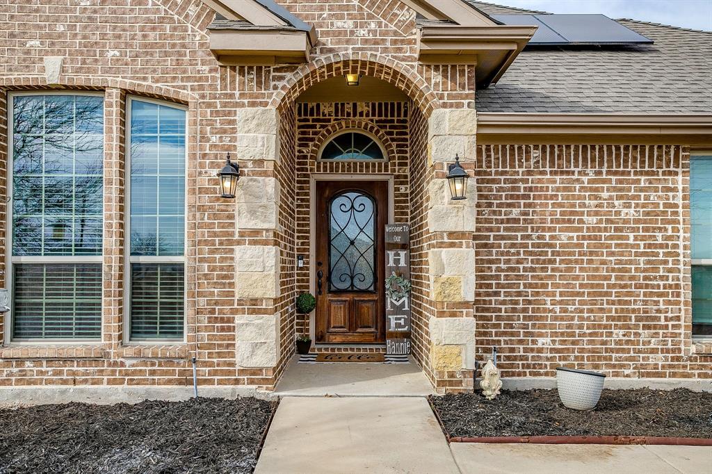 8005 Canyon Ridge Drive Godley, TX 76044 - Photo 4 of 40 a front view of a house with outdoor space