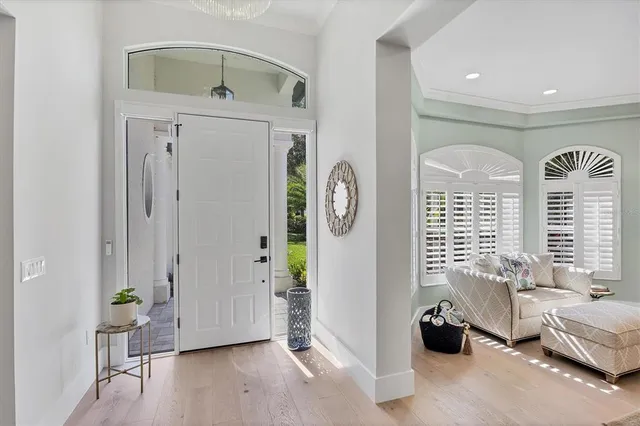 a living room with furniture and a view of kitchen