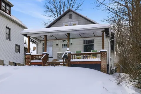 a view of a car park in front of house