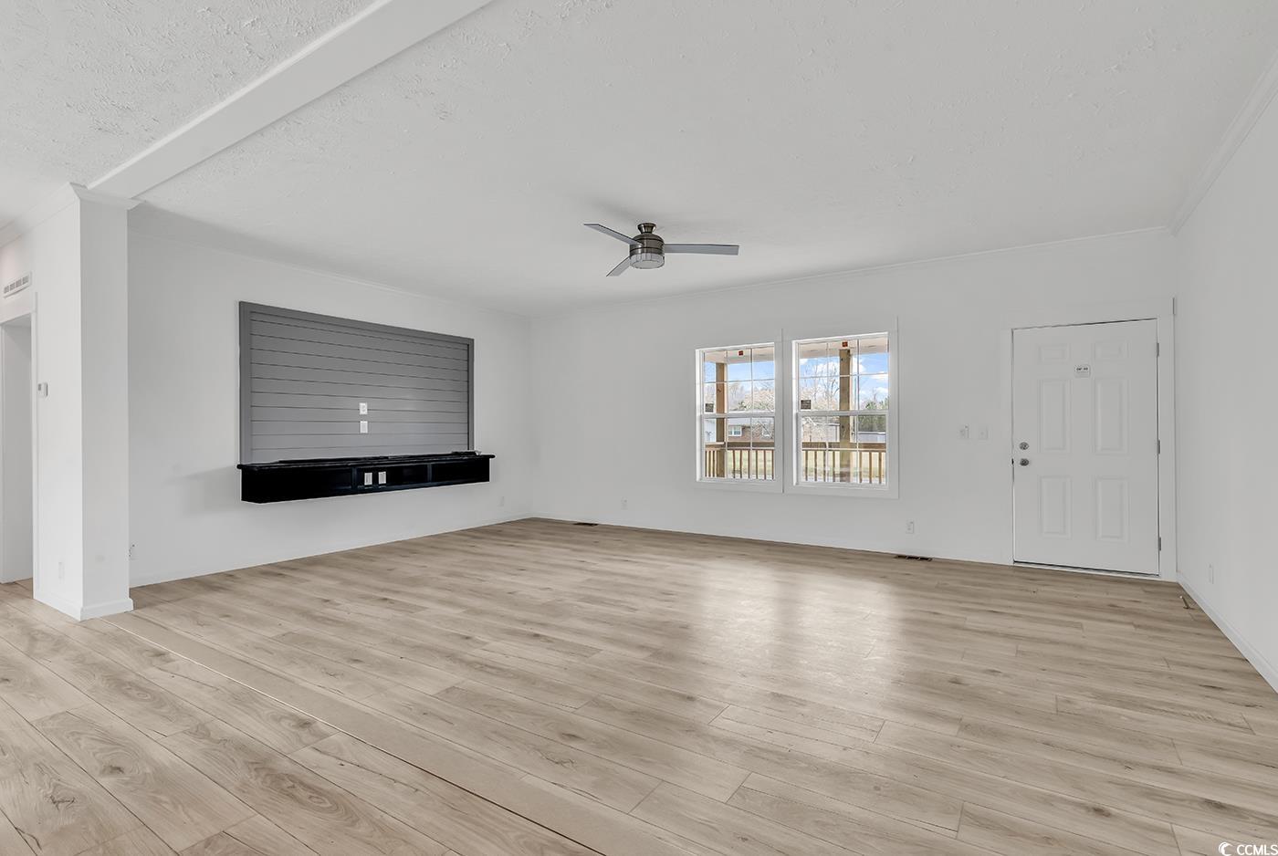 7768 Kerl Road Conway, SC 29526 - Photo 4 of 40 Unfurnished living room featuring light wood finished floors, ceiling fan, and a textured ceiling