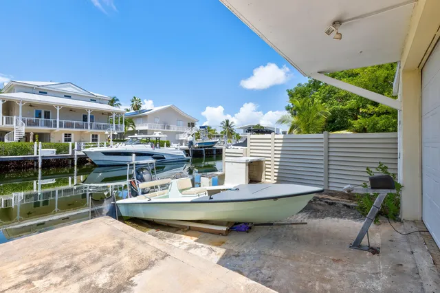 a view of swimming pool with outdoor seating and green space
