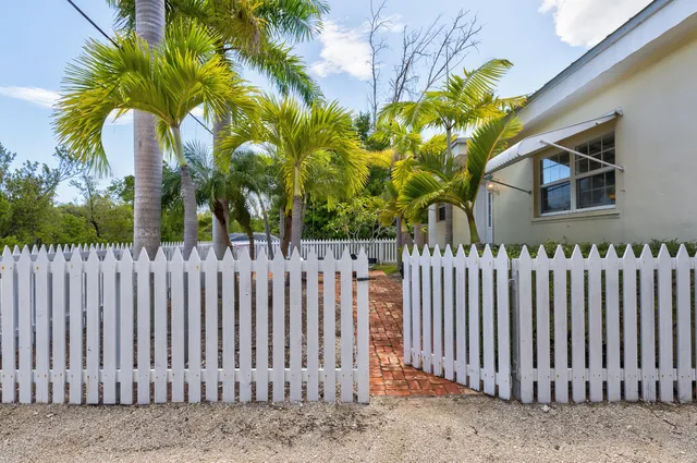 a kitchen with wooden cabinets a sink dishwasher and a stove with wooden floor