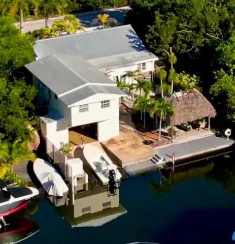 a kitchen with stainless steel appliances granite countertop a stove a refrigerator a dining table and chairs with wooden floor