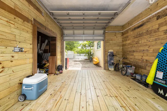 a view of a patio with couches table and chairs under an umbrella with a fireplace