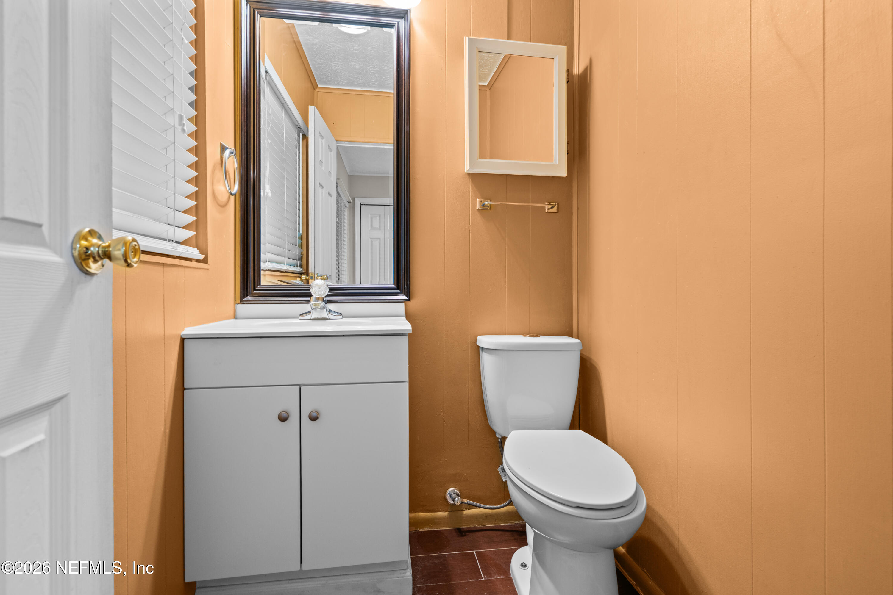 253 Cowry Road St. Augustine, FL 32086 - Photo 19 of 27 a bathroom with a toilet a sink and mirror